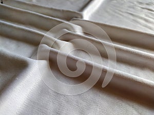 Elegant soft foldings of silk fabric with tint of pink. photo