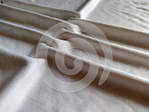 Elegant soft foldings of silk fabric with tint of pink.