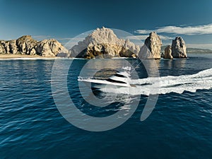 Elegant sportfishing yacht in the ocean in Cabo, Mexico sailing leisurely through a tranquil bay