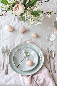 Elegant spring table setting with eggs and blooming flowers. . AI Generated