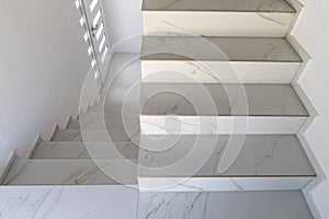 Elegant staircase with white marble steps