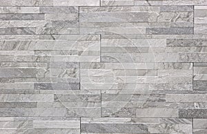 Elegant stone cladding wall made of gray granite with different shades