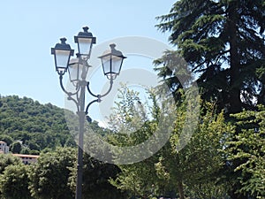 Elegant street lamp surrounded by trees in Laveno, north Italy