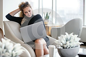 Elegant, stylish, and classy business woman working from computer in luxury office interior, glamour and success lifestyle