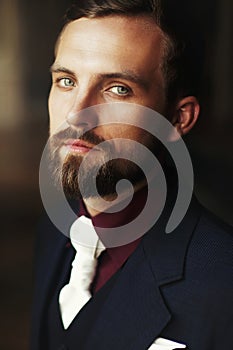 Elegant stylish handsome groom portrait. bearded man standing at