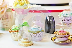 Elegant sweet table with cupcakes and other sweets for dinner or