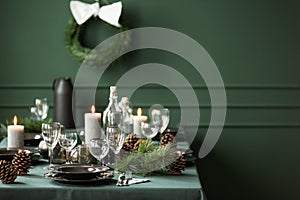 Elegant table set for christmas dinner, copy space on empty green wall