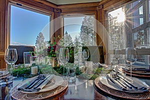 Elegant table set for dinner and beautiful window view.