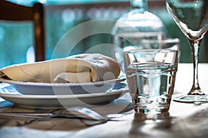 Elegant table set for dinning with white porcelaine dishes, vinta