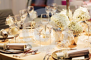 Elegant table set in soft creme for wedding or event party.