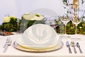 Elegant table set in soft creme for wedding or event party.