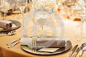 Elegant table set in soft creme for wedding or event party.