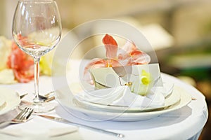 Elegant table set in soft creme for wedding or event party.