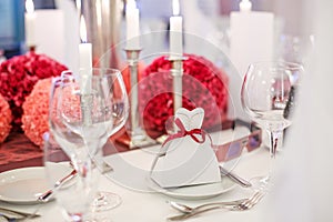 Elegant table set for wedding or event party in soft red and pi