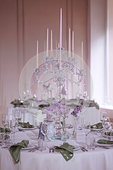 Elegant table setting with candelabra and purple flowers