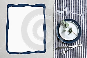 Elegant table setting and empty menu on marble table, flat lay. Space for text