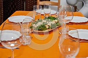 Elegant Table Setting with Glasses, Plates, and Delicacies for New Year's Celebration