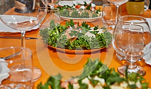 Elegant Table Setting with Glasses, Plates, and Delicacies for New Year's Celebration