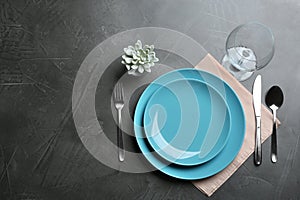 Elegant table setting on grey background. Space for text