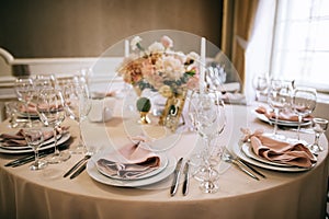 Elegant table setting for a wedding banquet, pastel beige decorations