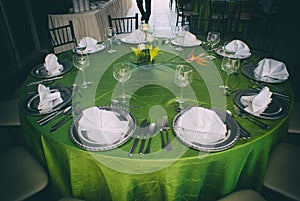 Elegant table with silver clutery and wineglasses photo