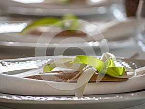 Elegant table with white dishes and wedding favorsElegant table with white dishes and wedding favors