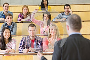 Elegant teacher with students at the lecture hall