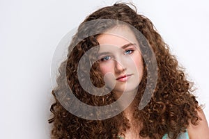 Elegant teenage girl with long curly hair