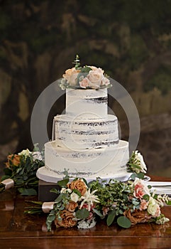 Elegant three tiered wedding cake at a wedding reception