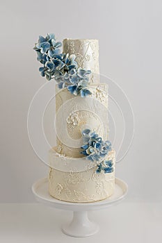 Elegant 3 Tier Wedding Cake With Piped Lace Accents And Edible F photo