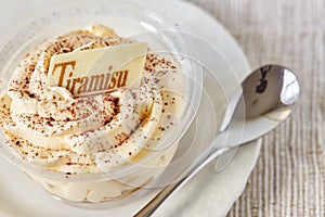 Elegant tiramisu cake in a glass, close up