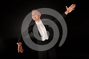 Elegant toung man dancing in studio with expression