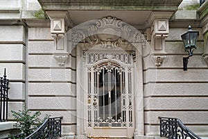 elegant townhouse entrance with ornate wrought iron grill on door