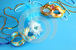 elegant venetian mask on blue wooden background