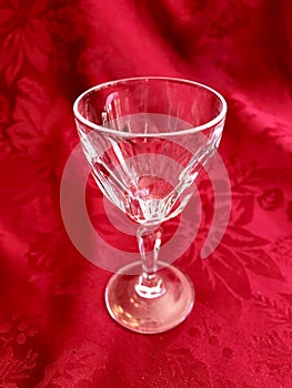 Elegant Vintage Cut Crystal Glass Stemware on Red Background