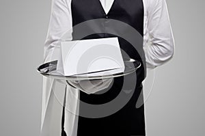 Elegant waiter with blank paper on tray