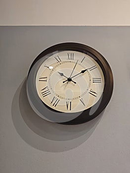 Elegant Wall Clock with Roman Numerals on Subtle Grey Background