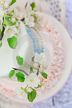Elegant wedding or birthday cake decorated with apple blossom branch