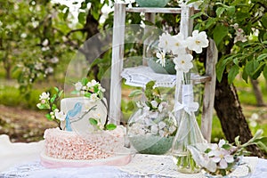 Elegant wedding or birthday cake decorated with apple blossom branch