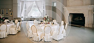 Elegant wedding reception white table arrangement, decoration with flowers and candles