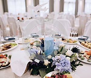 Elegant wedding table setting with flowers and blue  candle