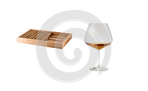 Elegant whiskey glass and wooden coaster isolated on white