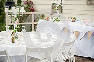 Elegant white chairs and table settings make up this wedding rec