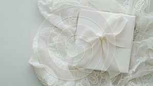 Elegant white gift box with satin ribbon on lace fabric