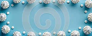 Elegant White Meringue Arrangement on Soft Blue Background with Copy Space for Text and Design