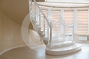 Elegant white natural wood stairs and large windows in the new house