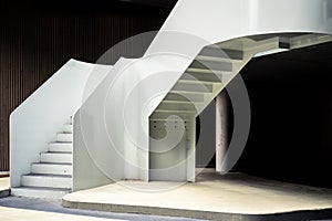 Elegant white stair case in a dark surrounding