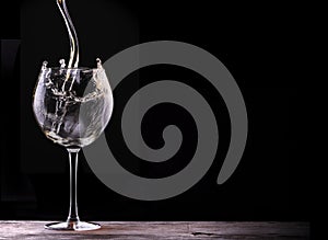 Elegant white wine glass in black background