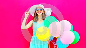 Elegant woman with an air colorful balloons is having fun