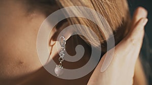 Elegant woman with beautiful earrings. Close up